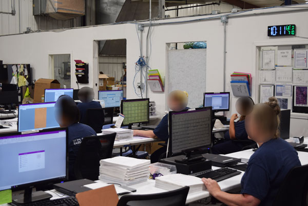 Incarcerated women in the imaging department working at their work stations